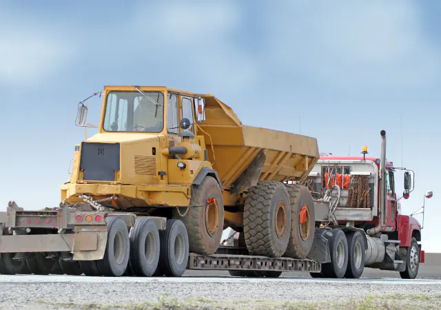 Articulated dump truck on trailer