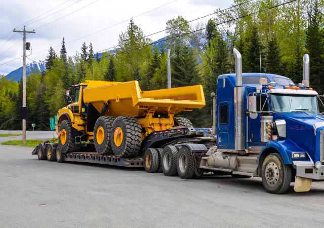 Dump truck on flatbed trailer
